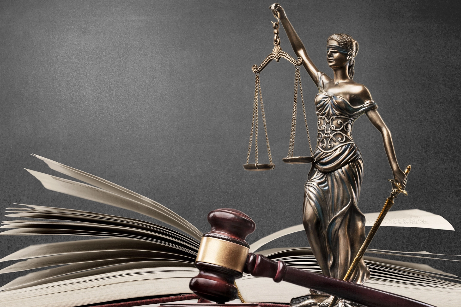 Image of Lady Justice over a legal book for BGRB Blog.